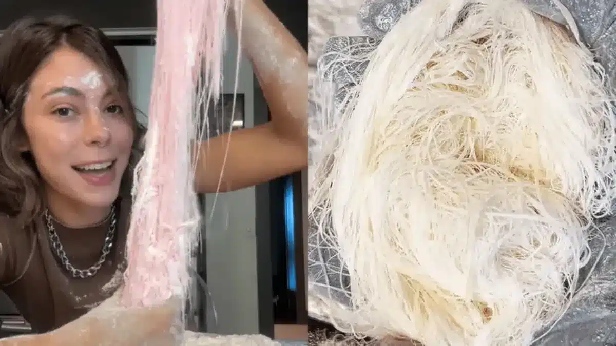 Mulher preparando o doce barba de dragão com massa açucarada