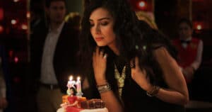 Imagem da série 'Dinheiro Sujo e Amor', onde a personagem celebra seu aniversário, em um momento cheio de emoções.