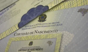 Certidões de nascimento em exibição, representando os serviços de registro civil disponíveis para a comunidade.v