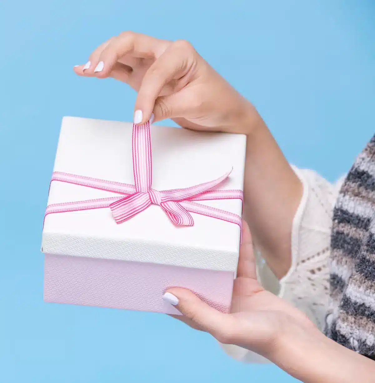 Caixa de presente delicada com laço rosa, destacando embalagem sofisticada para crochê