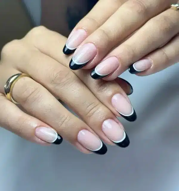 Unhas amendoada com francesinha preta e linha branca dupla, tendência moderna para o inverno de 2025.