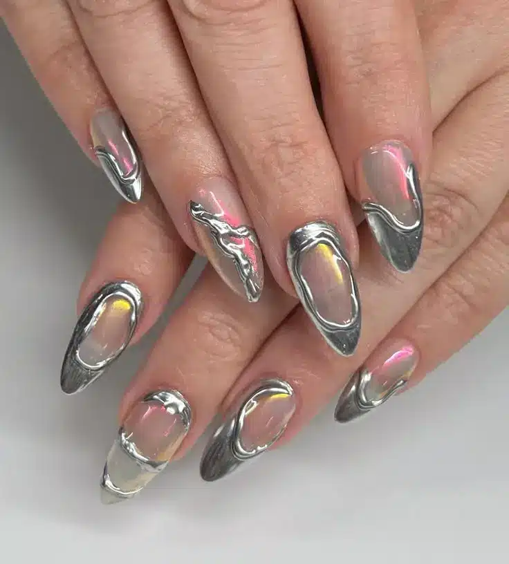 Unhas cromadas com acabamento metálico futurista, com brilho que reflete várias cores.