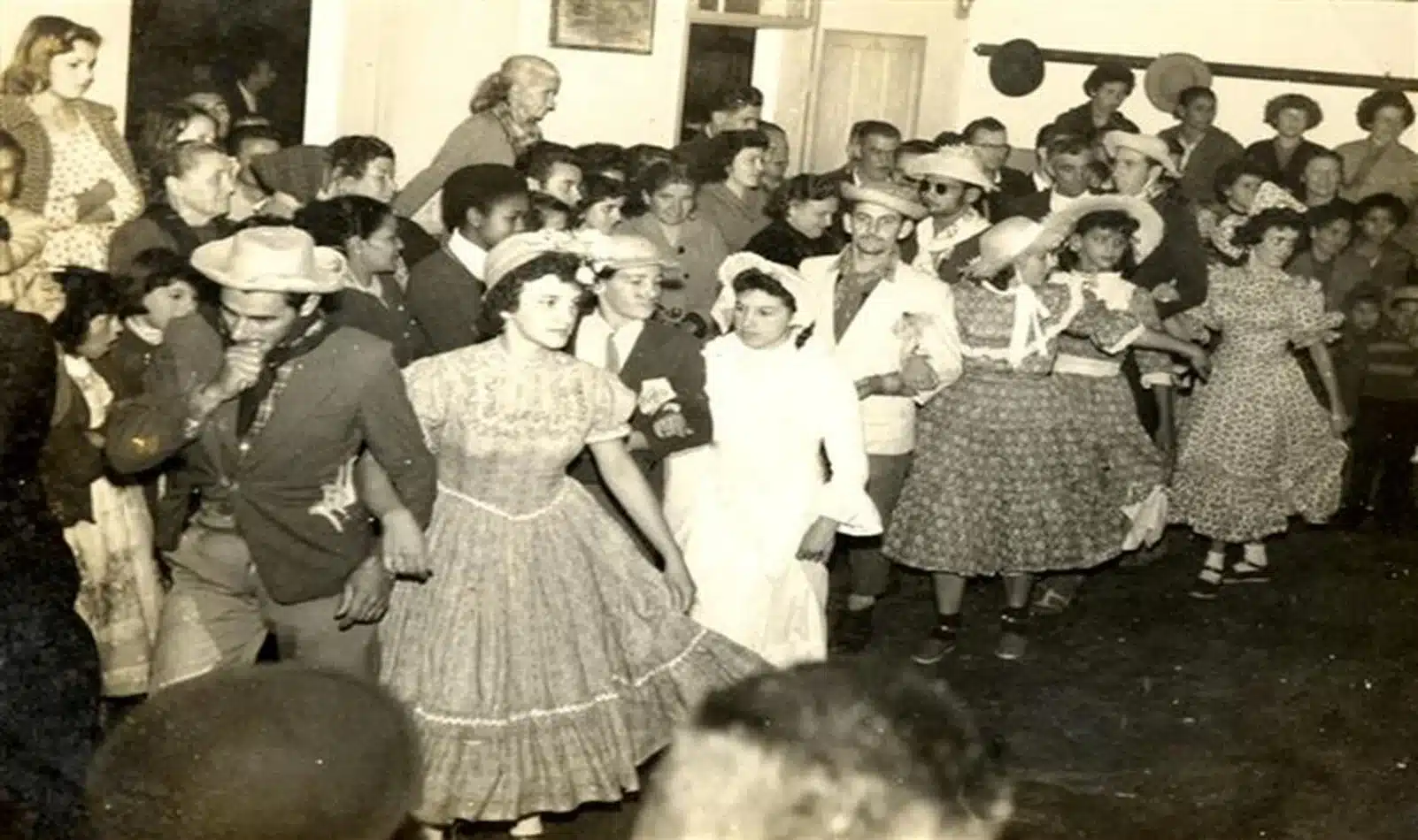 Dança da Quadrilha Junina no século XX com trajes típicos de festa de São João.