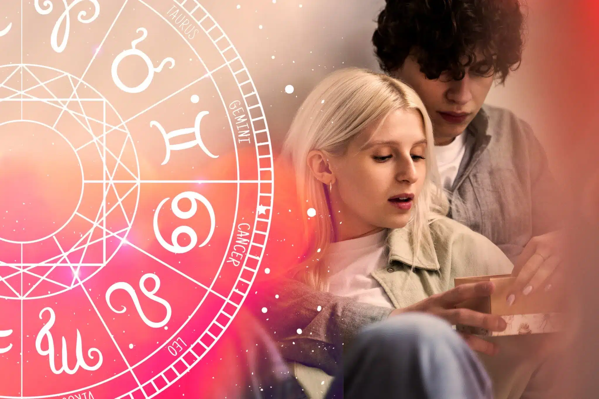 Casal jovem lendo previsões amorosas com roda zodiacal ao fundo