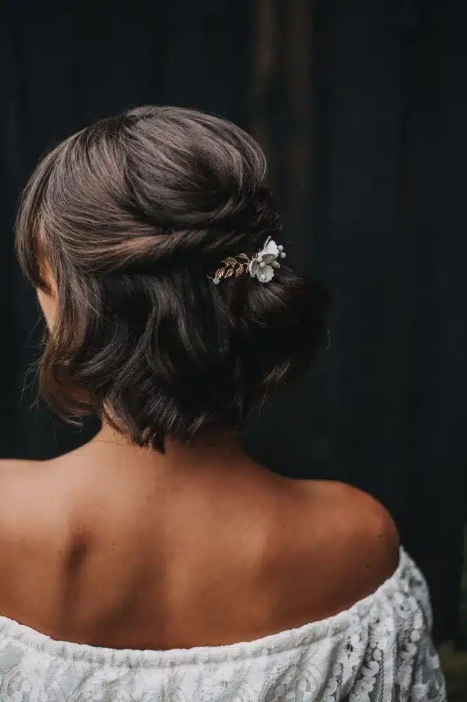 Mulher com cabelo semi-preso decorado com acessórios, elegante e charmoso.