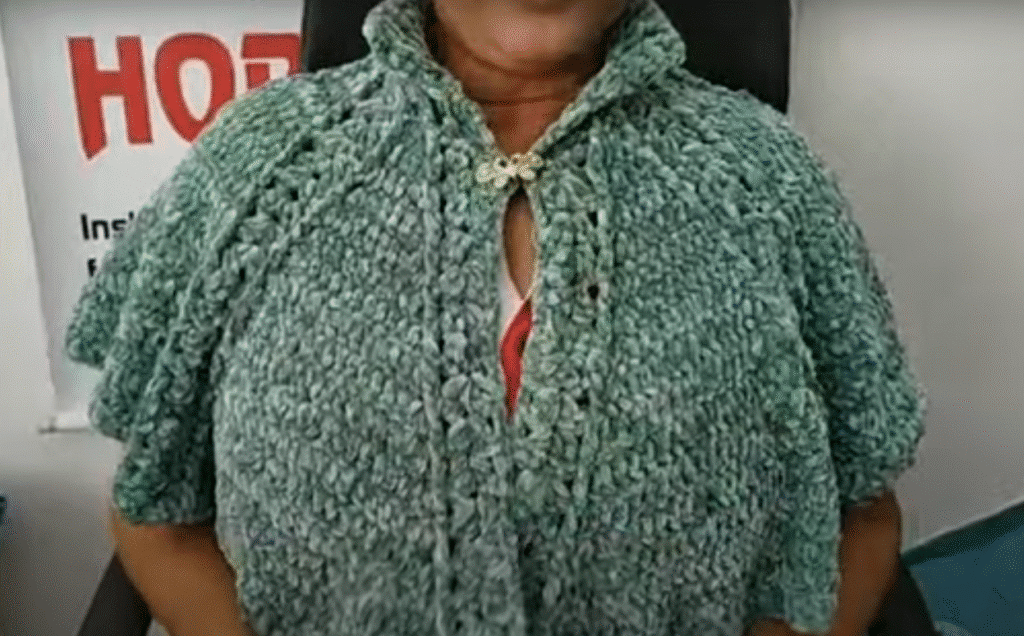 Pessoa usando pelerine de crochê verde feita à mão