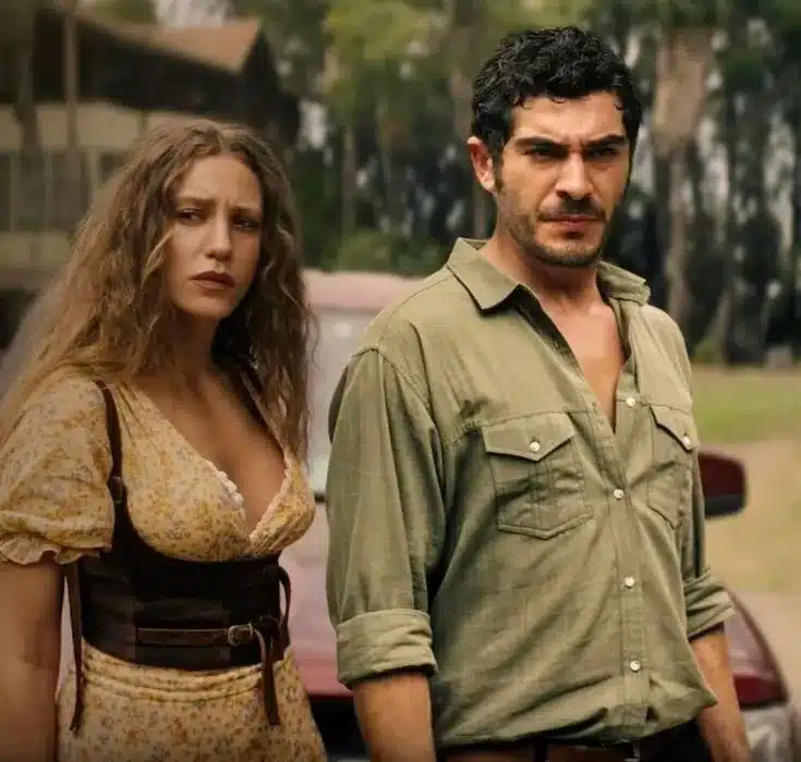 Casal com expressão séria ao ar livre em cena de novela turca.