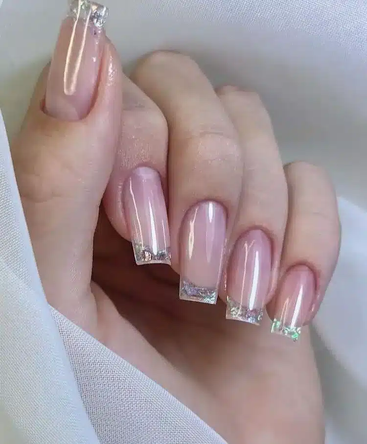 Unhas com francesinha reversa e flakes brilhantes