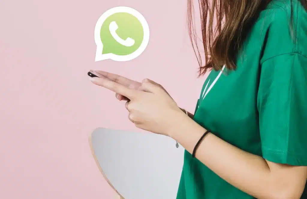 Pessoa usando WhatsApp no celular, com o ícone do aplicativo flutuando ao lado.