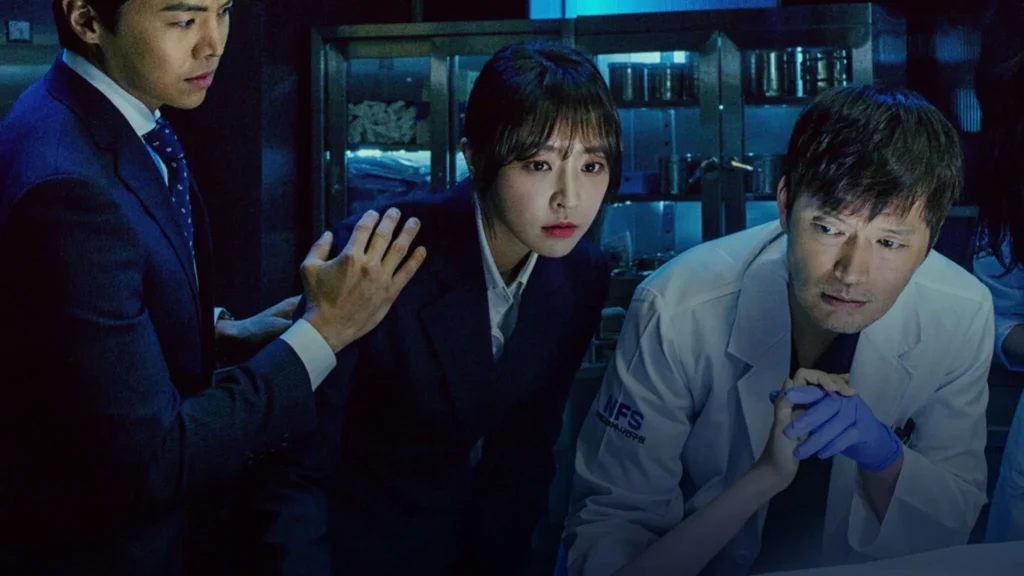 Médico legista e promotora investigando juntos em uma cena forense tensa.