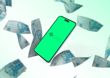 Imagem de um celular com a logo do Pix, cercado por notas de 100 reais.