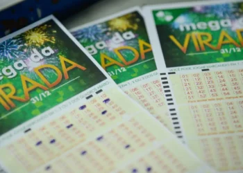 Ilustração de um bilhete de loteria da Mega-Sena sobre uma tela de smartphone com ícones de alerta de segurança digital, simbolizando o cuidado com golpes financeiros.