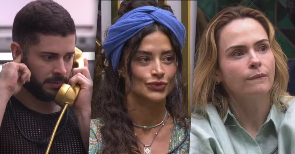Big Fone do Big Brother Brasil 26 em primeiro plano, com três participantes ao fundo observando o telefone, em clima de tensão e expectativa.