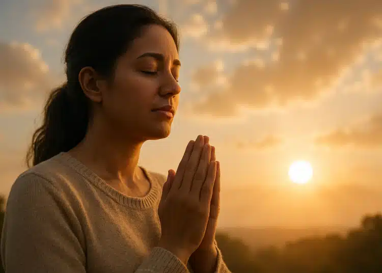 Mulher meditando ou orando ao entardecer