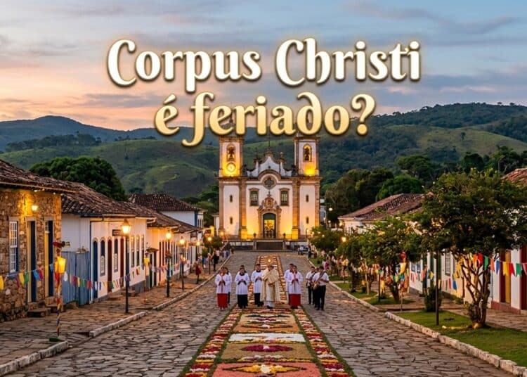 Sacerdotes caminham sobre tapete floral na rua de pedras, com Igreja Matriz de Santo Antônio ao fundo em Tiradentes, MG