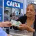 Beneficiária do INSS recebe pagamento em agência bancária, representando os pagamentos referentes a setembro liberados nesta semana.